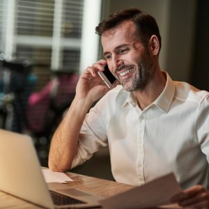 smiling-businessman-talking-by-mobile-phone